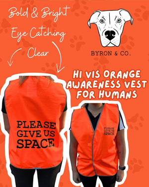 
                  
                    Orange awareness vest with 'Please Give Us Space' text on a bright orange background with 'Byron & Co.' branding.
                  
                